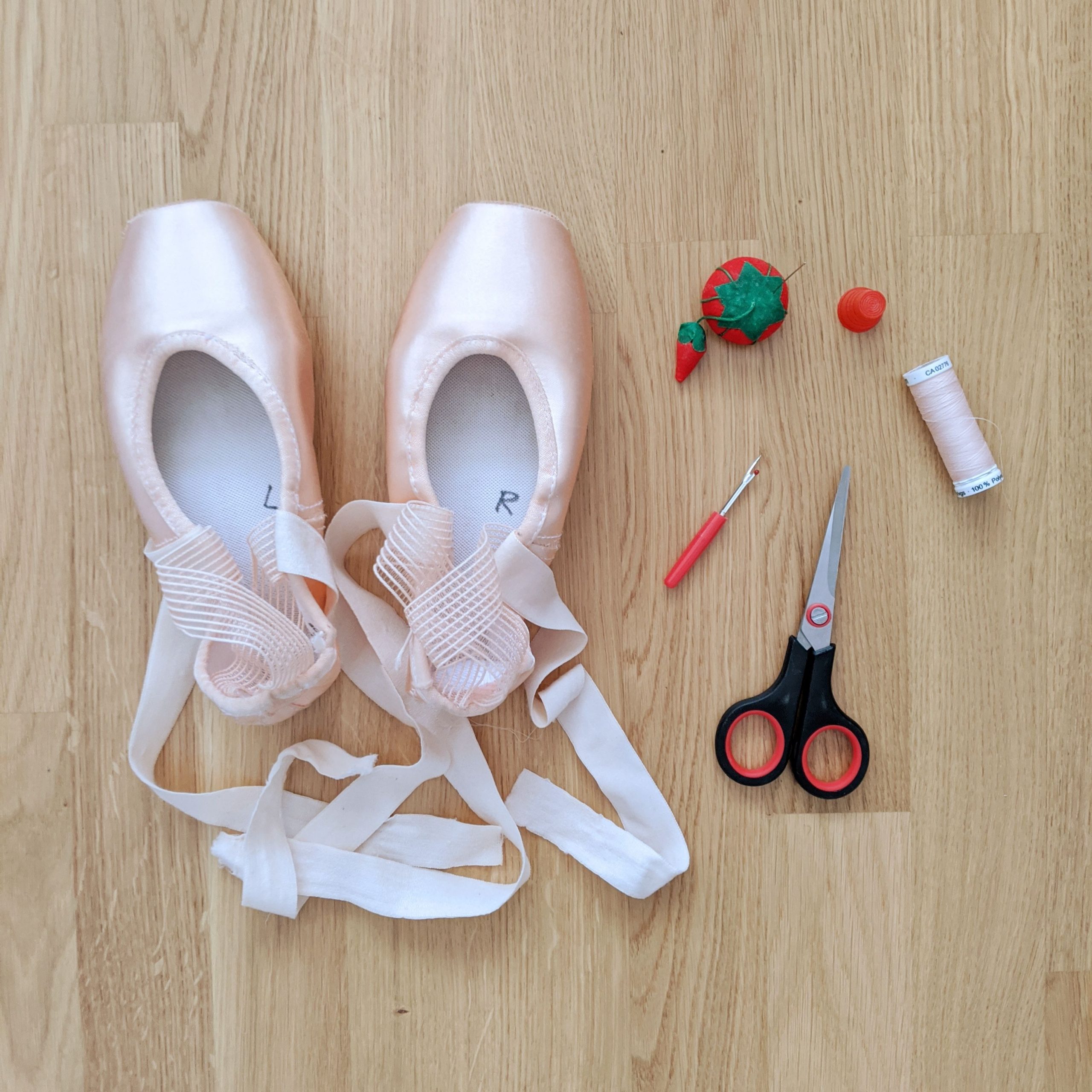 My pointe shoes post-repair alongside the tools I used.